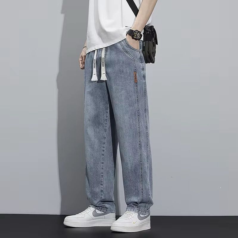 Light Wash Denim Joggers With Drawstring Waist And Tapered Cuffs