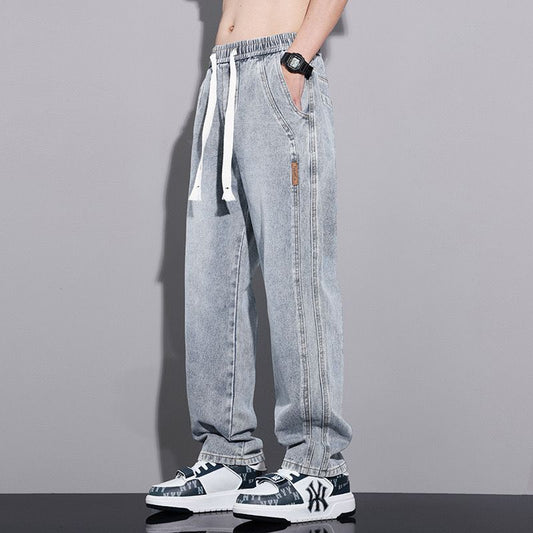 Light Wash Denim Joggers With Drawstring Waist And Tapered Cuffs